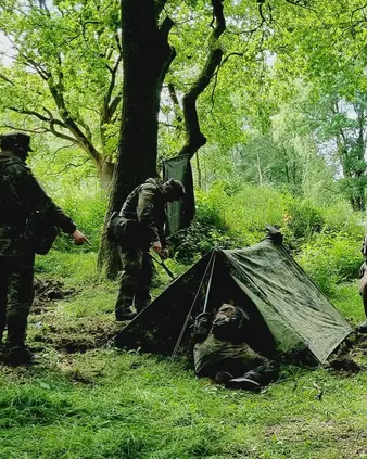 Soldaten mit Feldzelten im Wald